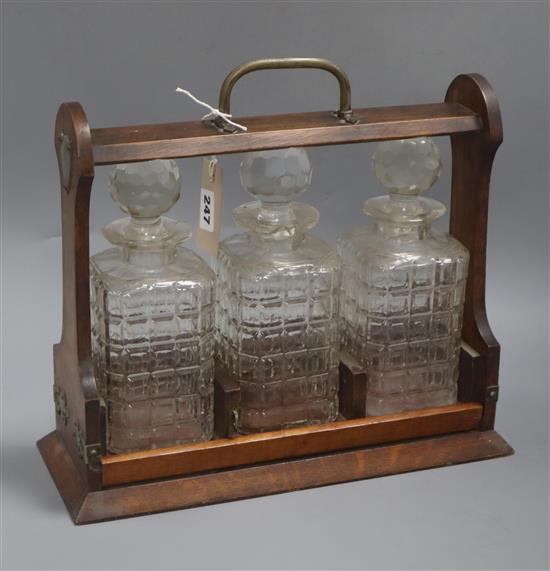 An oak three decanter tantalus